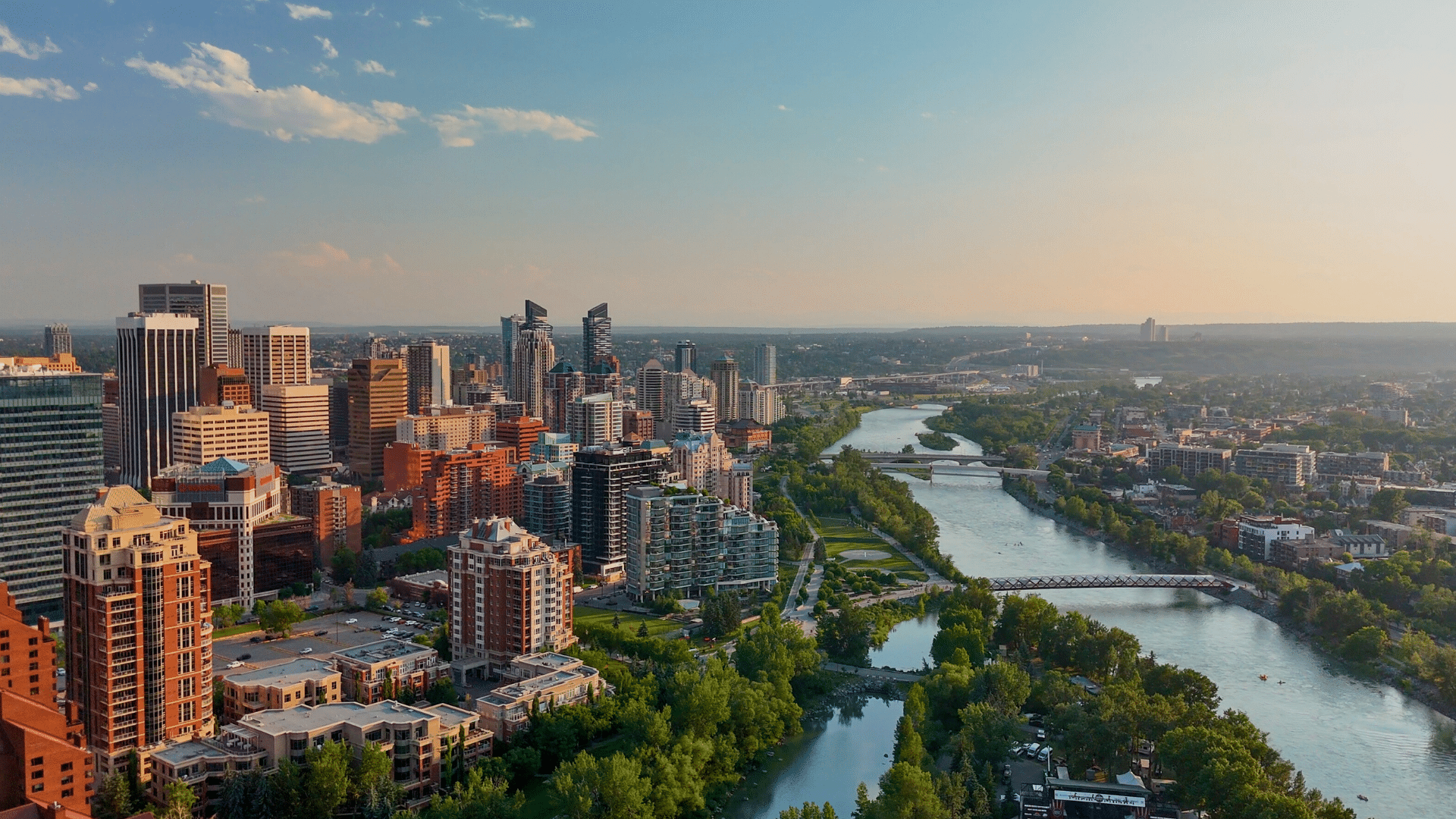 Relocating to Calgary guide featuring the downtown Calgary skyline and Bow River, highlighting lifestyle, neighbourhoods, and quality of life.