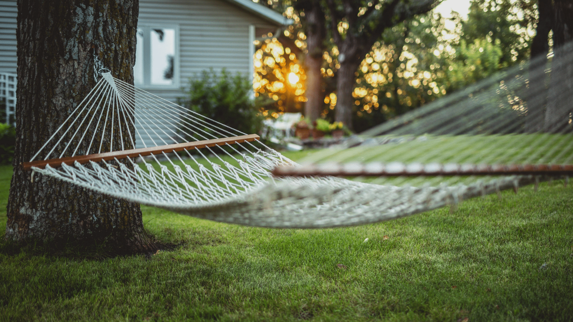 A backyard hammock surrounded by green space, representing the added space many homeowners enjoy in Calgary